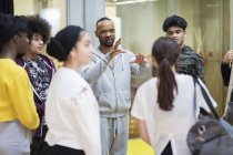 Male instructor leading teenagers in dance class studio — Stock Photo