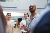Male instructor leading discussion in dance class studio — Stock Photo