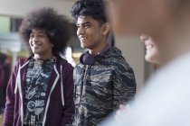 Smiling teenage dancers listening in dance class studio — Stock Photo