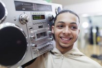 Close up portrait smiling, confident, cool teenage boy with boom box — Stock Photo
