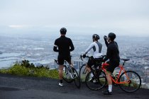 Gli amici ciclisti maschi si prendono una pausa, guardando la vista da trascurare — Foto stock