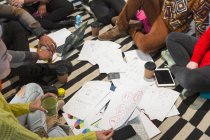 Creative business people meeting, brainstorming in circle on floor — Stock Photo