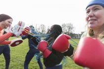 Happy people boxing in green park — Stock Photo