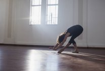 Graceful young female dancer practicing in dance studio — Stock Photo