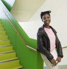 Portrait smiling, confident high school girl in stairway — Stock Photo