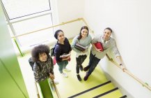 Portrait smiling high school students on stair landing — Stock Photo
