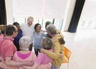 Active seniors hugging in circle — Stock Photo