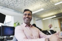 Smiling, confident businessman working in office — Stock Photo