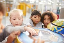 Crianças curiosas em exposição globo interativo no centro de ciência — Fotografia de Stock