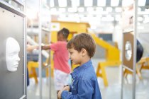 Curious boy looking at face in science center — Stock Photo
