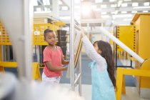 Curious girls playing at interactive exhibit in science center — Stock Photo