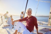 Portrait smiling man relaxing on sunny boat — Stock Photo