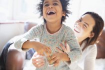 Playful mother and daughter laughing — Stock Photo