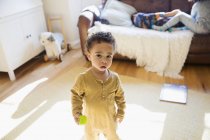 Portrait cute, innocent toddler boy in living room — Stock Photo