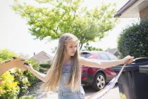 Girl recycling in driveway — Stock Photo