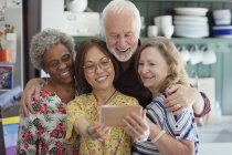 Active senior friends taking selfie with camera phone — Stock Photo