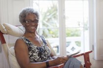 Portrait smiling, confident senior woman using digital tablet — Stock Photo
