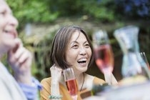 Laughing senior woman enjoying garden party — Stock Photo