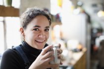 Портрет усміхненої молодої жінки п'є каву — стокове фото