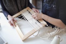 Women friends assembling string frame art — Stock Photo