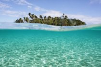 Tropical island beyond idyllic blue ocean water, Vava 'u, Tonga, Pacific Ocean — стоковое фото