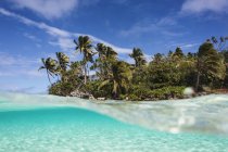 Tropical island beach beyond ocean surface, Vava 'u, Tonga, Pacific Ocean — стоковое фото