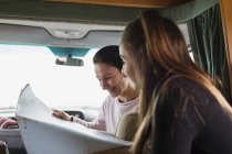 Mother and daughter looking at map in motor home — Stock Photo