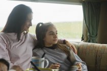 Affectionate mother and daughter enjoying breakfast in motor home — Stock Photo