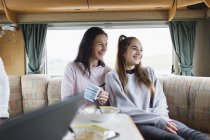 Happy mother and daughter enjoying breakfast in motor home — Stock Photo