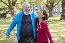Affectionate active senior couple walking in park — Stock Photo