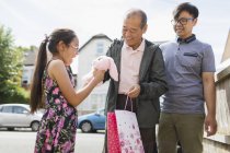 Grandfather surprising granddaughter with stuffed animal — Stock Photo