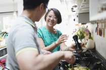 Couple cooking at kitchen stove — Stock Photo