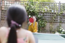 Mother and daughter playing table tennis — Stock Photo