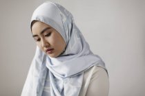 Serene young woman wearing blue silk hijab — Stock Photo