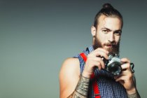 Portrait hipster man with retro camera — Stock Photo