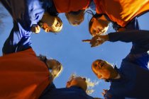 Girls soccer team listening to coach in huddle — Stock Photo
