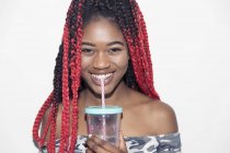 Portrait smiling, confident teenage girl drinking smoothie — Stock Photo
