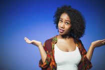 Portrait young woman shrugging — Stock Photo