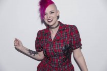 Portrait smiling, confident young woman with pink mohawk — Stock Photo