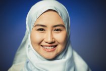 Close up portrait smiling, confident young woman wearing blue silk hijab — Stock Photo