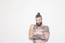 Portrait confident male hipster with bare chest and tattoos — Stock Photo