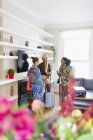 Young women friends with suitcases talking in house rental — Stock Photo