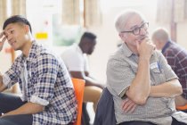 Men talking and listening in group therapy in community center — Stock Photo