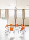 Orange chairs arranged in circle in community center — Stock Photo