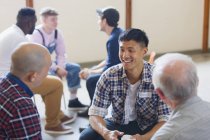 Uomini che parlano e ascoltano in terapia di gruppo — Foto stock