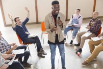Man with microphone talking, leading group therapy — Stock Photo