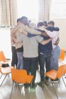Men hugging in huddle in group therapy — Stock Photo