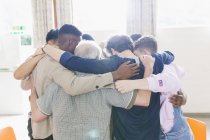 Men standing in huddle in prayer group — Stock Photo