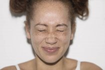 Портрет грайлива молода жінка з веснянками стискає очі закриті — стокове фото