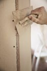 Close up construction worker plastering wall — Stock Photo